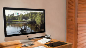 Desktop computer and stationeries on a wooden desk