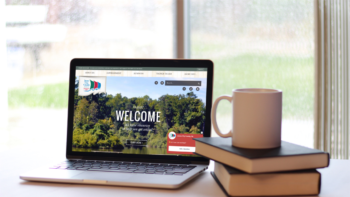 Laptop and coffee mug on a wooden table
