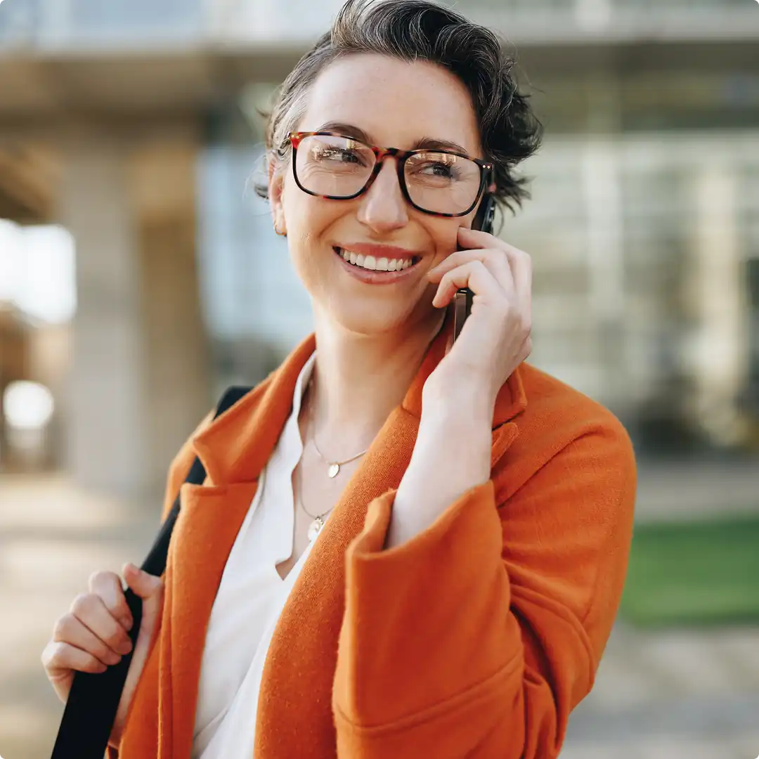 Woman smiling on the phone outside