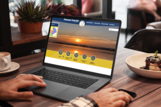 Laptop displaying the Putnam County website homepage